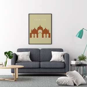 May include: A minimalist poster with a brown silhouette of a building with domes and arches on a beige background. The text "VENICE" is printed in white at the top of the poster.