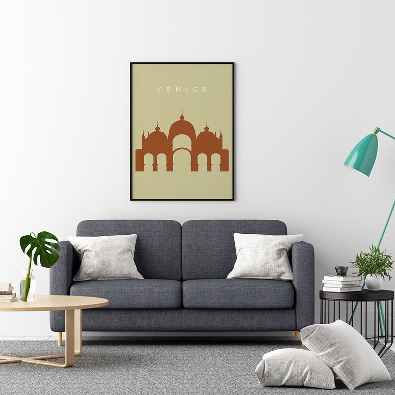 May include: A minimalist poster with a brown silhouette of a building with domes and arches on a beige background. The text "VENICE" is printed in white at the top of the poster.
