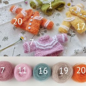 May include: Ten balls of yarn in various colors, including pink, orange, beige, and green. The yarn is labeled with numbers 7, 11, 16, 19, and 20.