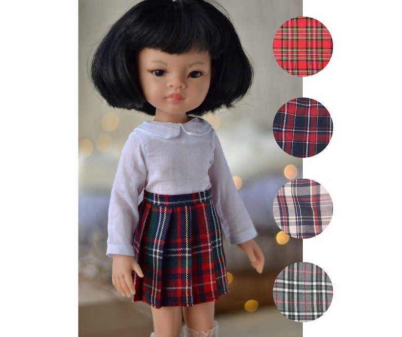 May include: A doll wearing a white collared shirt and a red, black, and white plaid skirt. The doll has black hair and brown eyes. The image also shows different plaid patterns in circles.