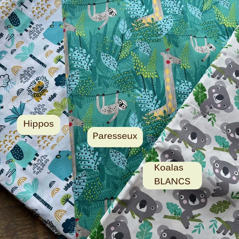 May include: Three fabric swatches with animal patterns. One features blue hippos, another has green sloths, and the third displays gray koalas. The fabric has a white background with the text "Hippos", "Paresseux", and "Koalas BLANCS".