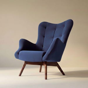 May include: A navy blue upholstered armchair featuring a high, tufted backrest, curved armrests, and a deep seat cushion. The chair is supported by four angled, dark brown wooden legs that provide a stable base for the seat structure.