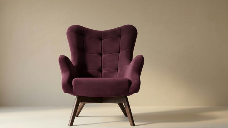 May include: A deep plum-coloured armchair featuring a high, tufted backrest with a grid pattern, curved armrests, and a cushioned seat. The chair is supported by four angled, dark brown wooden legs that provide a stable base for the structure.