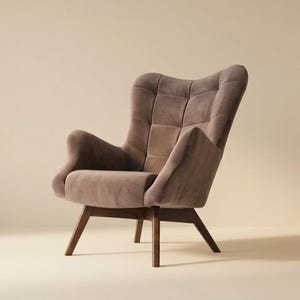 May include: A taupe-coloured armchair featuring a high, tufted backrest with a grid pattern, curved armrests, and a cushioned seat. The chair is supported by four angled, dark brown wooden legs that provide a stable base for the upholstered frame.