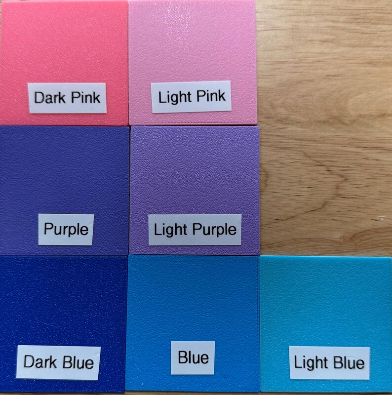 May include: Nine colorful square swatches in shades of pink, purple, and blue. Each swatch has a label with the color name: Dark Pink, Light Pink, Purple, Light Purple, Dark Blue, Blue, and Light Blue.