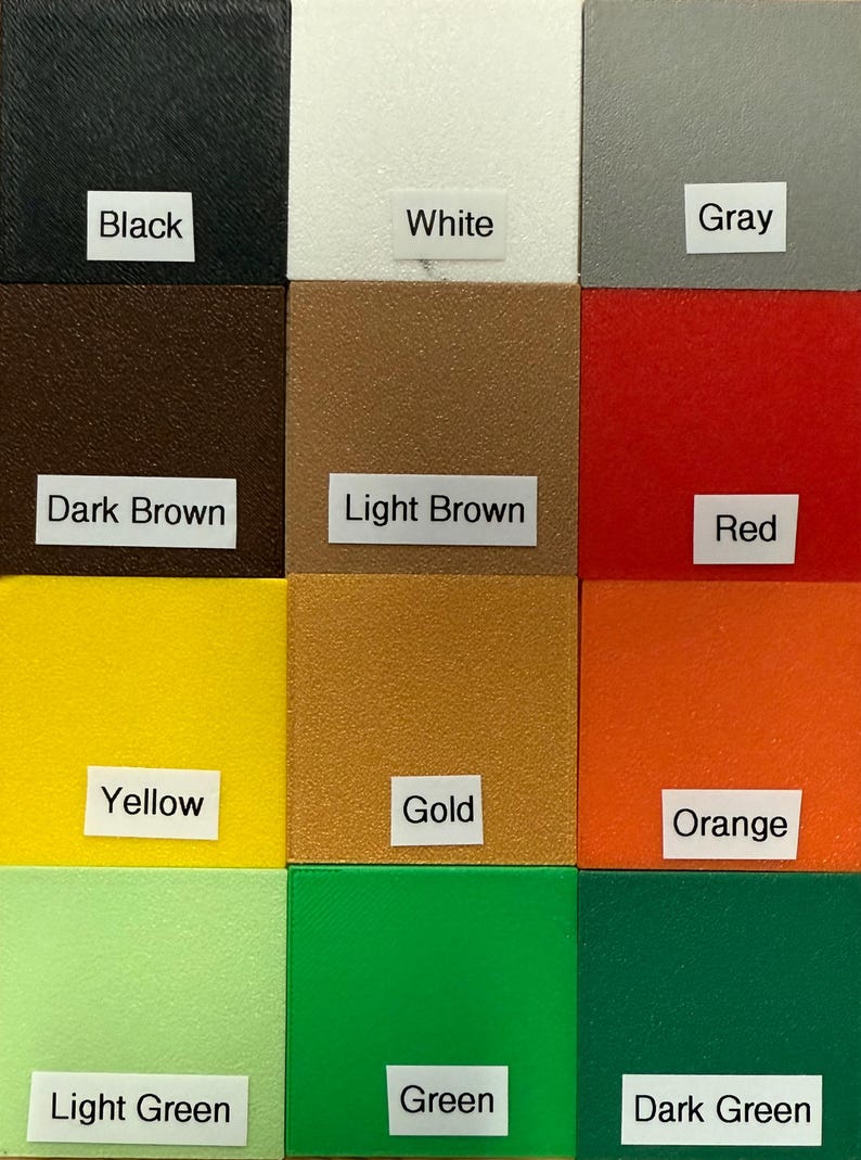 May include: A color palette featuring twelve distinct color swatches. The colors include black, white, gray, dark brown, light brown, red, yellow, gold, orange, light green, green, and dark green. Each color is labeled with a corresponding white rectangle.