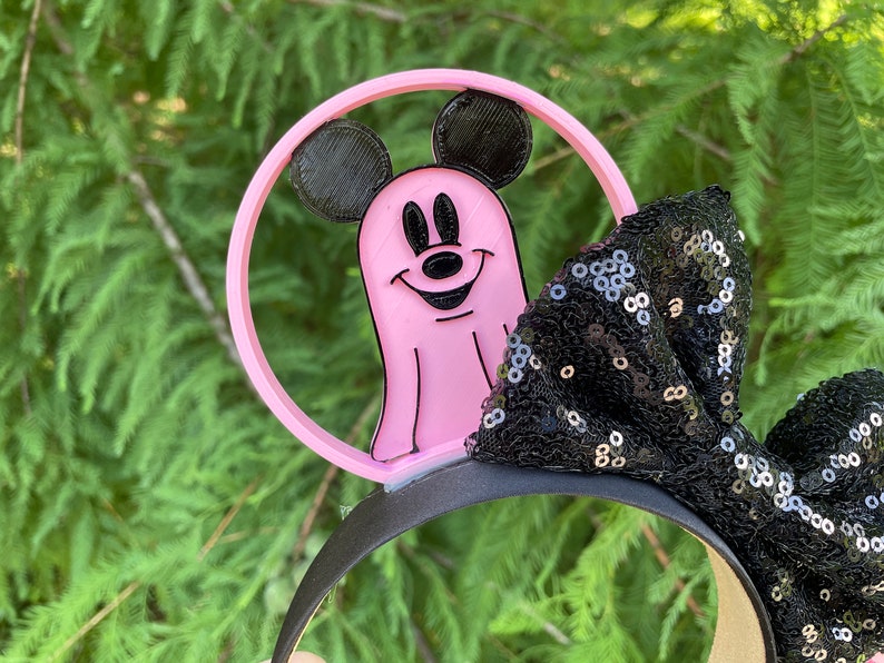May include: Pink Mickey Mouse ghost Halloween headband with a black sequined bow.