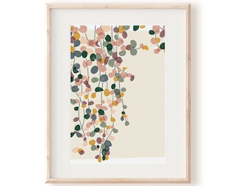 May include: A framed print of a stylized illustration of a hanging plant with green, pink, and yellow leaves. The background is a light beige color.
