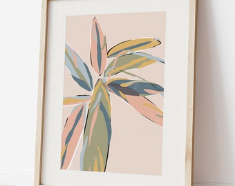May include: A framed print of a stylized illustration of a tropical plant with pink, green, blue, and yellow leaves on a light pink background.