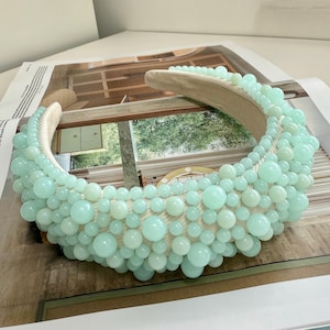 Peut inclure: Un serre-tête bleu clair avec une rangée de perles rondes. Le serre-tête est fait d'un matériau doux et flexible et est parfait pour ajouter une touche d'élégance à n'importe quelle tenue.