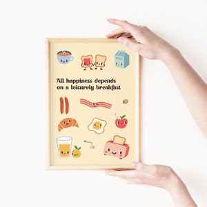 May include: A yellow print with the text "All happiness depends on a leisurely breakfast" and illustrations of breakfast foods with cartoon faces. The illustrations include a cup of coffee, toast, bacon, sausage, a croissant, an egg, an apple, a glass of orange juice, and a toaster.