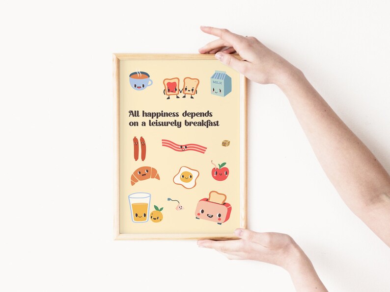 May include: A yellow print with the text "All happiness depends on a leisurely breakfast" and illustrations of breakfast foods with cartoon faces. The illustrations include a cup of coffee, toast, bacon, sausage, a croissant, an egg, an apple, a glass of orange juice, and a toaster.