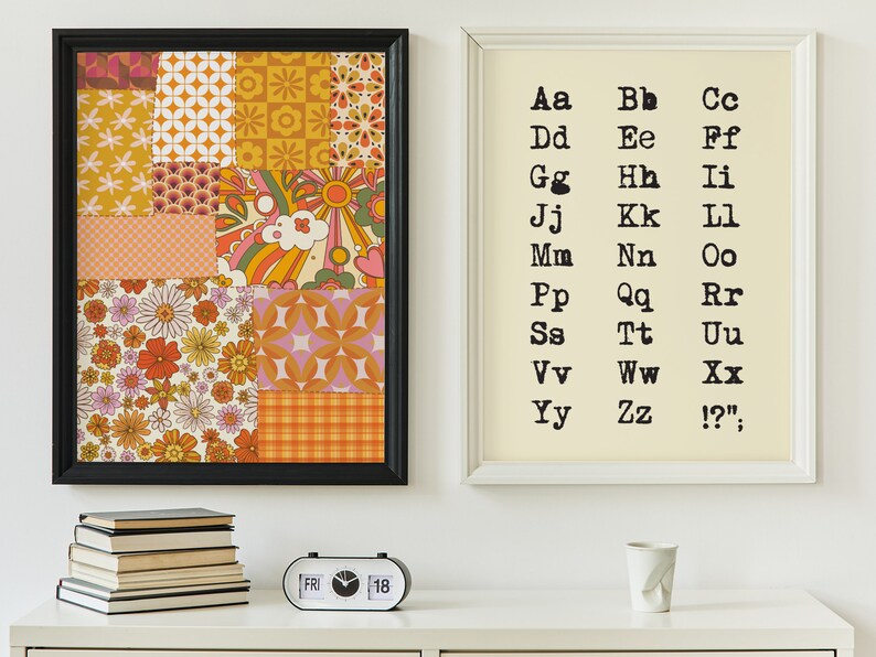 May include: Two framed prints on a white wall. The print on the left is a collage of colorful geometric and floral patterns. The print on the right is a white background with black text that reads "Aa Bb Cc Dd Ee Ff Gg Hh Ii Jj Kk Ll Mm Nn Oo Pp Qq Rr Ss Tt Uu Vv Ww Xx Yy Zz !?'".