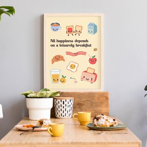 May include: A yellow poster with a quote about breakfast: "All happiness depends on a leisurely breakfast." The poster features cartoon illustrations of breakfast foods, including toast, eggs, bacon, a croissant, orange juice, and a toaster.
