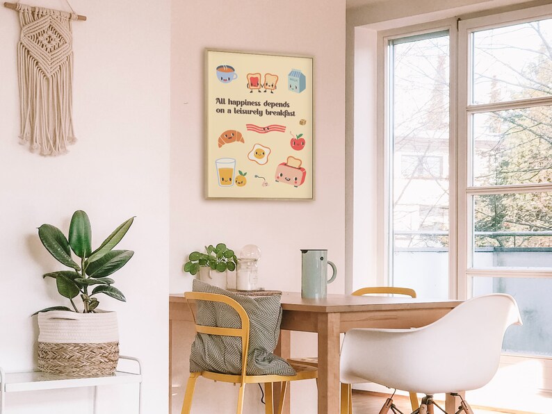 May include: A yellow and white poster with a cartoon illustration of breakfast foods with faces. The text on the poster reads "All happiness depends on a leisurely breakfast."