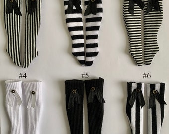 May include: Six pairs of black and white striped knee-high socks with black bows. The socks are numbered 1 through 6.