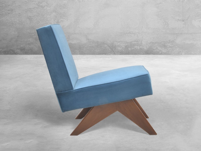 May include: A blue upholstered chair with a wooden frame and a unique angled base.
