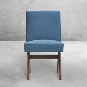 May include: A blue upholstered chair with a wooden frame. The chair has a simple design with a rectangular seat and back.