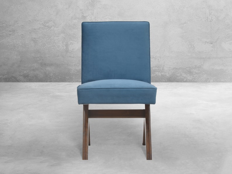 May include: A blue upholstered chair with a wooden frame. The chair has a simple design with a rectangular seat and back.