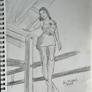 May include: A black and white pencil drawing of a woman standing on a wooden railing. She is wearing a short black dress with a belt and has long dark hair. The drawing is signed "Jan J. Cetin 2023".