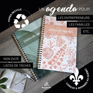 May include: Two spiral bound notebooks with different designs. The notebook on the left has a green and white watercolour design with the text "Listes de tâc" and "NON DATÉ LISTES DE TÂCHES". The notebook on the right has a pink and white floral design with the text "Listes de tâches" and "LES ENTREPRENEURS LES FAMILLES ETC.". Both notebooks have gold spiral binding.