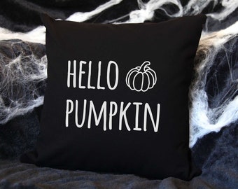 May include: Black throw pillow with white text that says "Hello Pumpkin" and a white outline of a pumpkin.