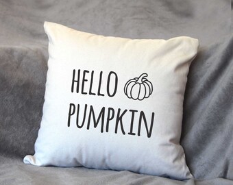 May include: White throw pillow with black text that reads "Hello Pumpkin" and a black line drawing of a pumpkin.