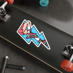 May include: A sticker featuring a cartoon illustration of a person wearing pink roller skates and a pink skirt, skating on a blue lightning bolt.