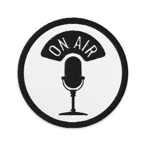 May include: Black and white embroidered patch with a microphone and the words "ON AIR" in a circle.