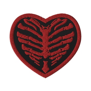 May include: Red heart-shaped patch with a black embroidered ribcage design.