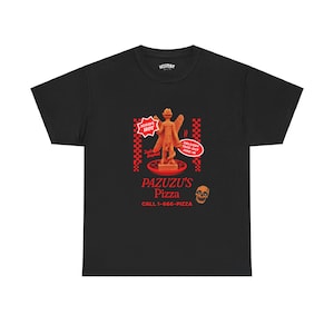 May include: Black t-shirt with a red and white illustration of a demon holding a pizza. The text "PAZUZU'S Pizza" and "CALL 1-666-PIZZA" is printed in red.