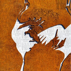 May include: A rusty metal wall art sculpture of a crane with its head raised and a smaller bird perched on its back. The sculpture is cut out of the metal, creating a silhouette against the rusty background.