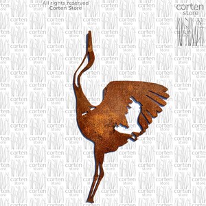 May include: A rusty metal sculpture of a crane with its wings spread. The sculpture is in a standing position with its head tilted back. The sculpture is on a white background.