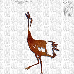 May include: A rusty metal crane sculpture with a long neck and long legs. The crane is standing on a white background.