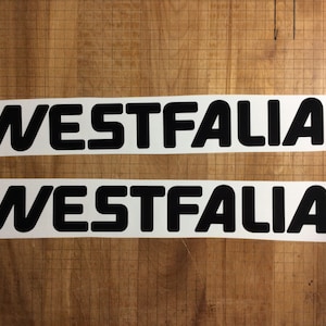 May include: Two white stickers with the word "WESTFALIA" printed in black, bold, sans-serif font.