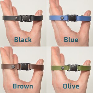 May include: Four leather wristbands with a metal buckle and a metal stud. The wristbands are shown in black, blue, brown, and olive.