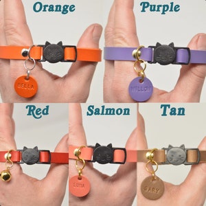 May include: Six different colored cat collars with a cat-shaped buckle and a metal ring for a tag. The collars are orange, purple, red, salmon, tan, and brown. Each collar has a different name tag attached to it: Bella, Willow, Luna, Gary.
