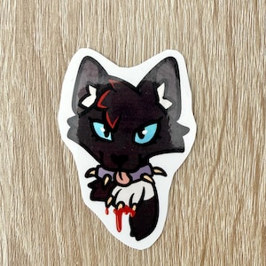 May include: A sticker featuring a black cat with blue eyes, a red lightning bolt on its forehead, and a purple collar with sharp teeth. The cat's paw is bloody, and its tongue is sticking out.