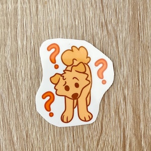 May include: A sticker featuring a cartoon dog with a puzzled expression. The dog is light brown with a fluffy tail and ears. Three orange question marks surround the dog, emphasizing the theme of confusion.