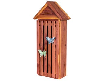 May include: A wooden butterfly house with a gabled roof and a slatted front. The house is painted a reddish brown color and has two butterfly decorations on the front.