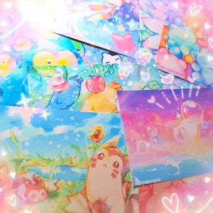 May include: A collection of colorful art prints featuring whimsical illustrations. The prints showcase various designs, including cartoon animals, flowers, and dreamy landscapes. The color palette includes blues, pinks, and purples, with a touch of sparkle.