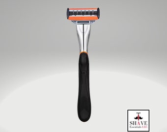May include: A silver and black razor with an orange blade. The razor has a textured black handle.