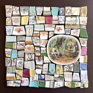 May include: A mosaic artwork composed of various porcelain fragments. The pieces feature floral patterns, geometric designs, and text fragments, arranged around a central circular image of figures in a forest setting. The color palette includes blues, pinks, yellows, and greens.