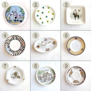 May include: A collection of nine ceramic dishes including a Disneyland plate, a shamrock-patterned plate, a square horse-themed dish, a black and white striped floral saucer, an oval floral dish, a gold-rimmed saucer, a horse head ashtray, a Berlin plate, and a Pullman saucer.