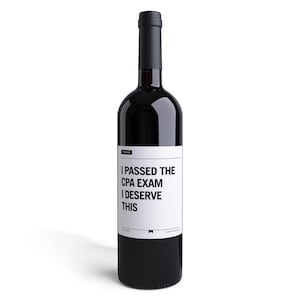 May include: A black wine bottle with a white label that reads "I passed the CPA exam I deserve this".