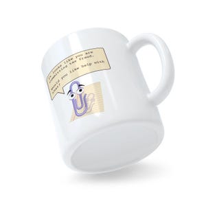 May include: White ceramic mug with a purple paperclip cartoon character with googly eyes. The paperclip is holding a speech bubble that says "It looks like you are committing tax fraud. Would you like help with that?"