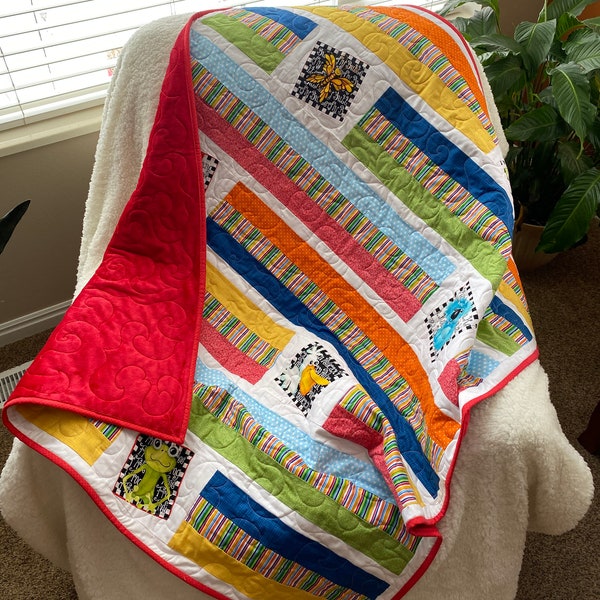 Wonky Strip Quilt for a boy or girl with a plush red minky back