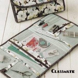 May include: A floral print sewing kit with the text "Atkinson Designs" and "one of life's simple pleasures". The kit is open, revealing various sewing tools and supplies. The bottom of the kit has the word "Classmate".