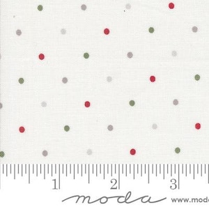 May include: White fabric with a scattered polka dot pattern in red, green, and gray. The fabric is marked with a ruler in inches and the text "moda" appears twice.