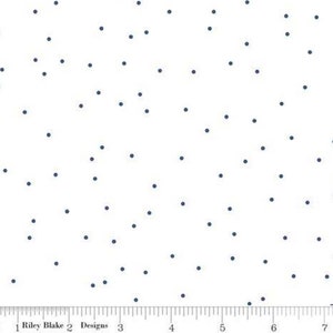 May include: White fabric with a scattered pattern of small, dark blue dots.